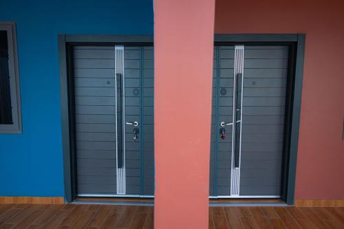a pair of doors in a room with blue at CMP APARTMENTS in Kasoa