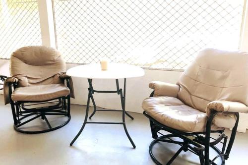 two chairs and a table and a chair and a table at 8 Bedroom Subic Bay/300MBPS/Big Screened Lanai in Sawat