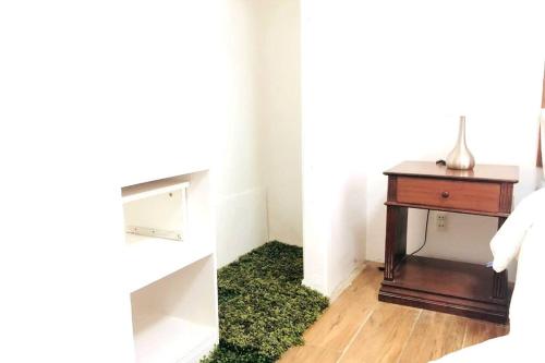 a room with a table and a green rug at 8 Bedroom Subic Bay/300MBPS/Big Screened Lanai in Sawat