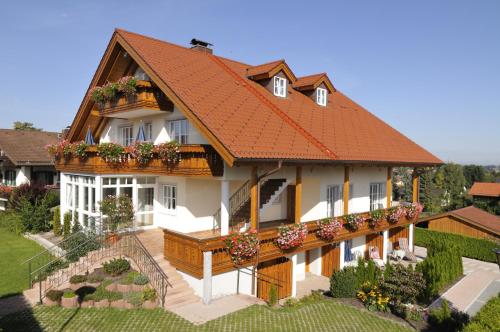 a rendering of a house with a roof at Boutique Hotel Angerer in Murnau am Staffelsee