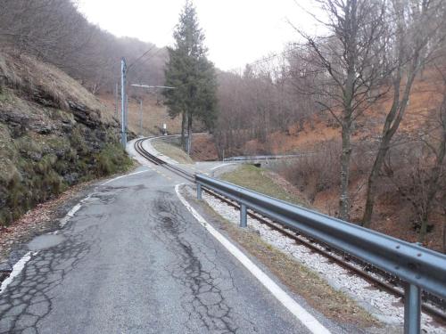 an empty road with a rail on the side of a hill at Panoramic apartment on Monte Generoso in Castel San Pietro