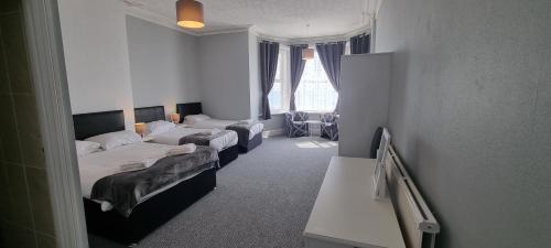a hotel room with two beds in a room at Royal Pier in Sandown