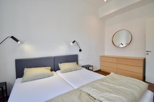 a bedroom with two beds and a mirror on the wall at Modern apartment with 2 bedrooms near Arena in Pula