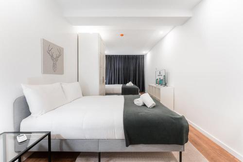 Postel nebo postele na pokoji v ubytování GuestReady - Uptown suites