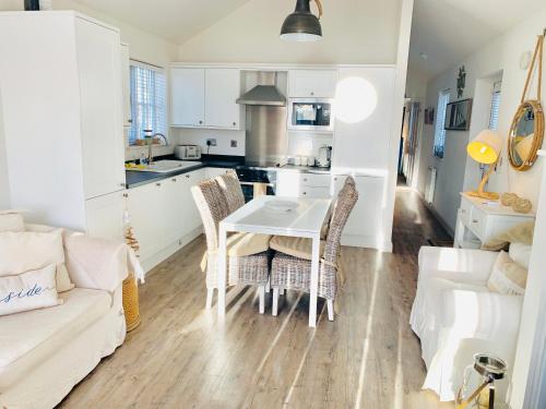 a kitchen and living room with a table and chairs at Boardwalk@TheBay, Filey in Filey