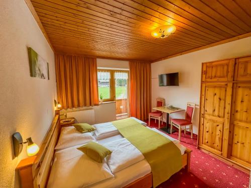 a bedroom with a large bed in a room at Frühstückspension Seeblick in Achenkirch