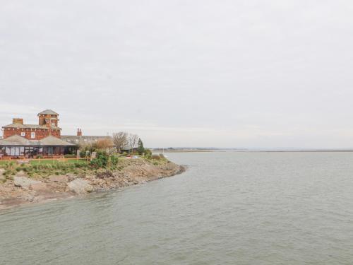 a house on the shore of a body of water at Villa Marina in Barrow in Furness