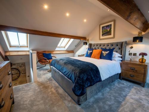 a bedroom with a large bed with blue and orange pillows at 1 Bed in Richmond 88588 in Easby