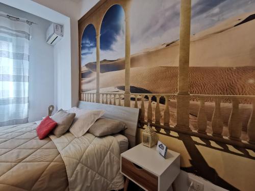 a bedroom with a bed with a painting on the wall at La Finestra Sul Mondo B&B in Rome