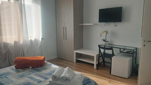 a bedroom with a bed and a tv on the wall at B&B Villa Giulia in Desenzano del Garda