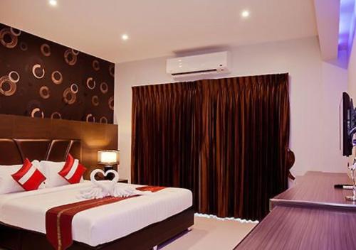 Un pat sau paturi într-o cameră la Constant Hotels & Resorts