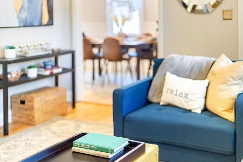 a living room with a blue couch and a table at Firefly Hideaway near Riverwalk in North Augusta