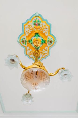 a gold chandelier hanging from a ceiling at Beautiful mansion with swimming pool and jacuzzi in Bilzen