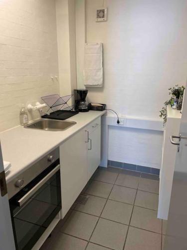 a kitchen with a sink and a counter top at City 6-bedroom, private parking. in Aalborg