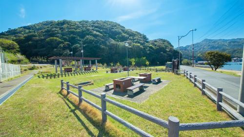 a park with benches and a gazebo next to a road at エトワール生石 in Yura