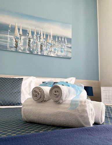 a bedroom with a bed with towels on it at Pensione Sorriso in Vernazza