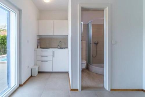 a bathroom with a shower and a sink and a toilet at Villa Ameli in Milna