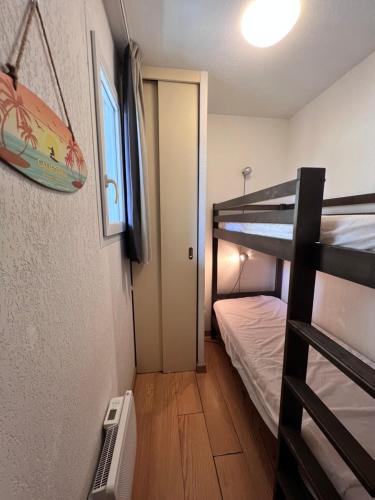ルダンヴィエルにあるAppt hyper-centre Loudenvielle 4 Personnes Jardin et Terrasseの小さな客室で、二段ベッド1組と二段ベッド1組が備わります。