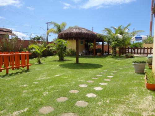 a garden with a path in the grass at Chalés Flamboyant in Caraguatatuba