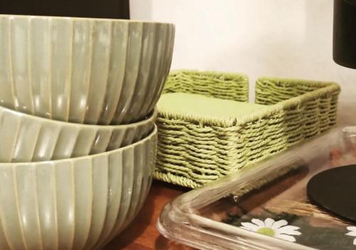 a stack of white bowls and baskets on a table at Bilocale alla Ginestra in Lastra a Signa