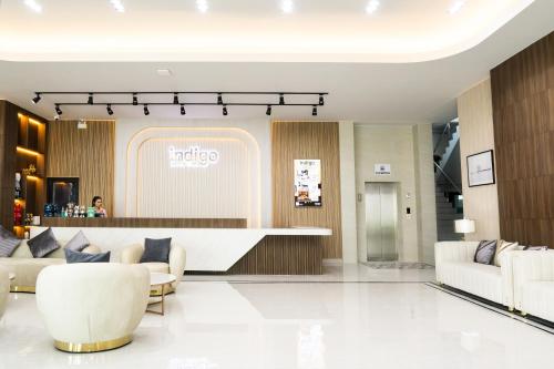 a lobby with couches and a counter in a store at indigo Hotel Hatyai in Ban Kohong