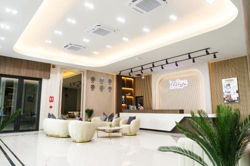a lobby of a hotel with chairs and a counter at indigo Hotel Hatyai in Ban Kohong