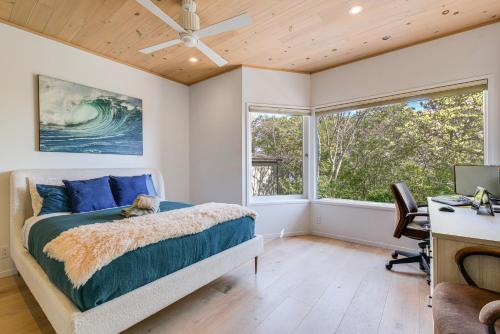 a bedroom with a bed and a desk and windows at Sausalito Oasis - 3 Mi to Golden Gate Bridge! in Sausalito