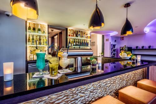 a bar with glasses on a counter at CityClass Hotel Alter Markt in Cologne