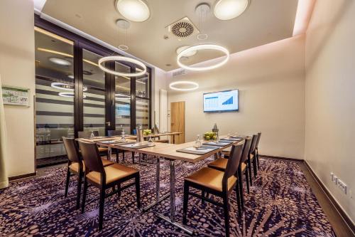 a conference room with a long table and chairs at CityClass Hotel Alter Markt in Cologne