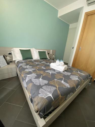 a large bed in a room with a bedspread with towels on it at Pensione Sorriso in Vernazza