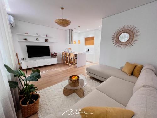 a living room with a couch and a table at Dune Apartments, San Pietro Resort in Lalëz
