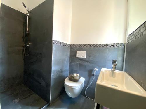 a bathroom with a toilet and a sink at Pensione Sorriso in Vernazza