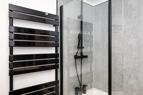 a shower in a bathroom with a glass shower backdoor at Promenade View - seafront hideaway in Eastbourne