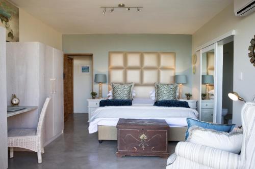 a bedroom with a large bed and a couch at 43 On Sandstone in Somerset West