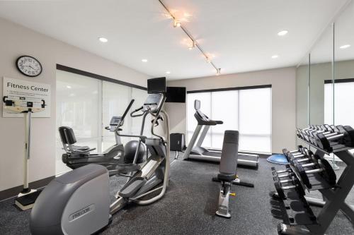 a gym with treadmills and exercise bikes in a room at Holiday Inn Express Savannah Airport by IHG in Savannah