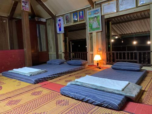 three beds sitting on the floor in a room at Mai chau Horizon Homestay in Mai Chau