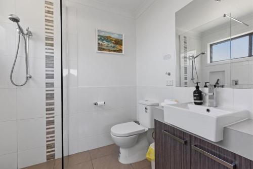 a bathroom with a toilet and a sink and a shower at Elevation in Paynesville