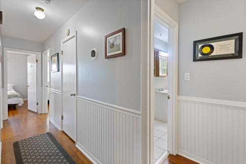 a hallway of a home with white walls at Spacious 5BR Home 10 Min Walk to Augusta Ntl Golf in Augusta