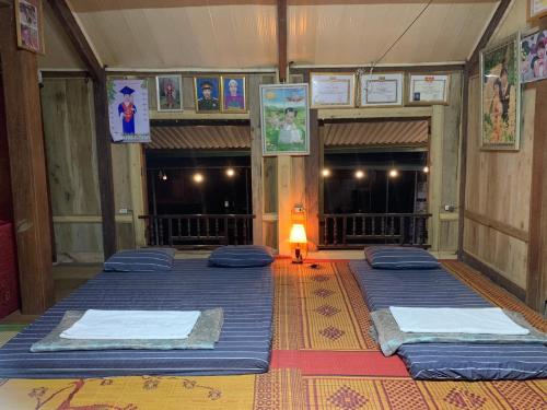 a group of four beds in a room at Mai chau Horizon Homestay in Mai Chau