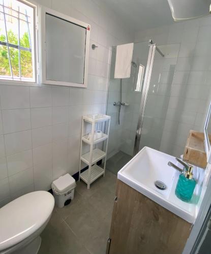 a bathroom with a toilet and a sink and a shower at Hostal Avenida by Bossh! Hotels in Chipiona
