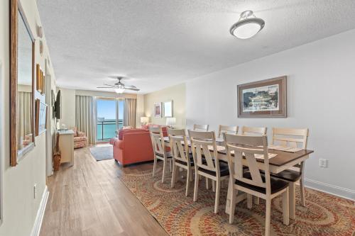 a dining room and living room with a table and chairs at Bahama Sands PH3 - Oceanfront - Crescent Beach Section in Myrtle Beach