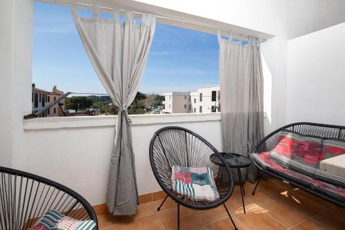 a balcony with two chairs and a window at APARTMENT MAJER 2 in Medulin
