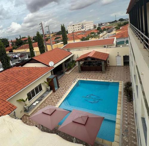 an overhead view of a swimming pool with umbrellas at Locanda group B&B in Luanda
