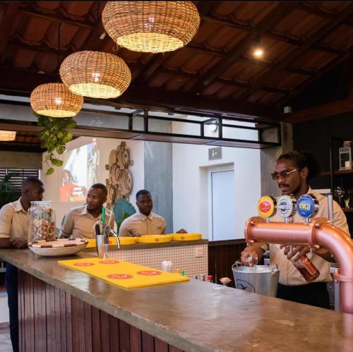 a group of men standing at a counter in a restaurant at Locanda group B&B in Luanda