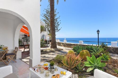 a patio with a table and a view of the ocean at Los Canarios 122 by VillaGranCanaria in Patalavaca