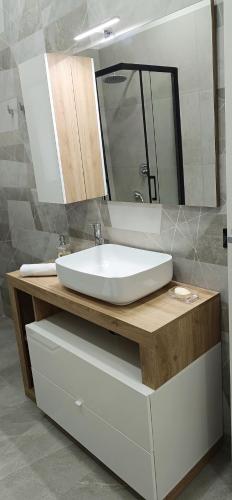 a bathroom with a sink and a mirror at I Coralli di Brucoli in Brucoli