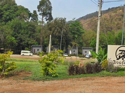a view of a campsite with a sign and trees at Riverhill khaoyai บ้านกล่อง in Ban Bung Toei