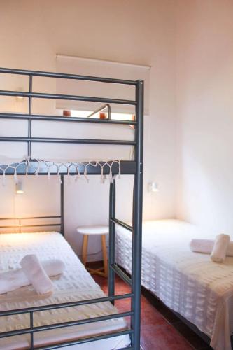 a bedroom with two bunk beds and a table at Casa dos Magalhães in Vila do Porto