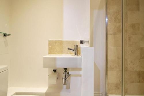 a bathroom with a sink and a shower at Noa Residence in Oxford