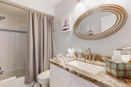 a bathroom with a sink and a toilet and a mirror at BayCation in Tampa